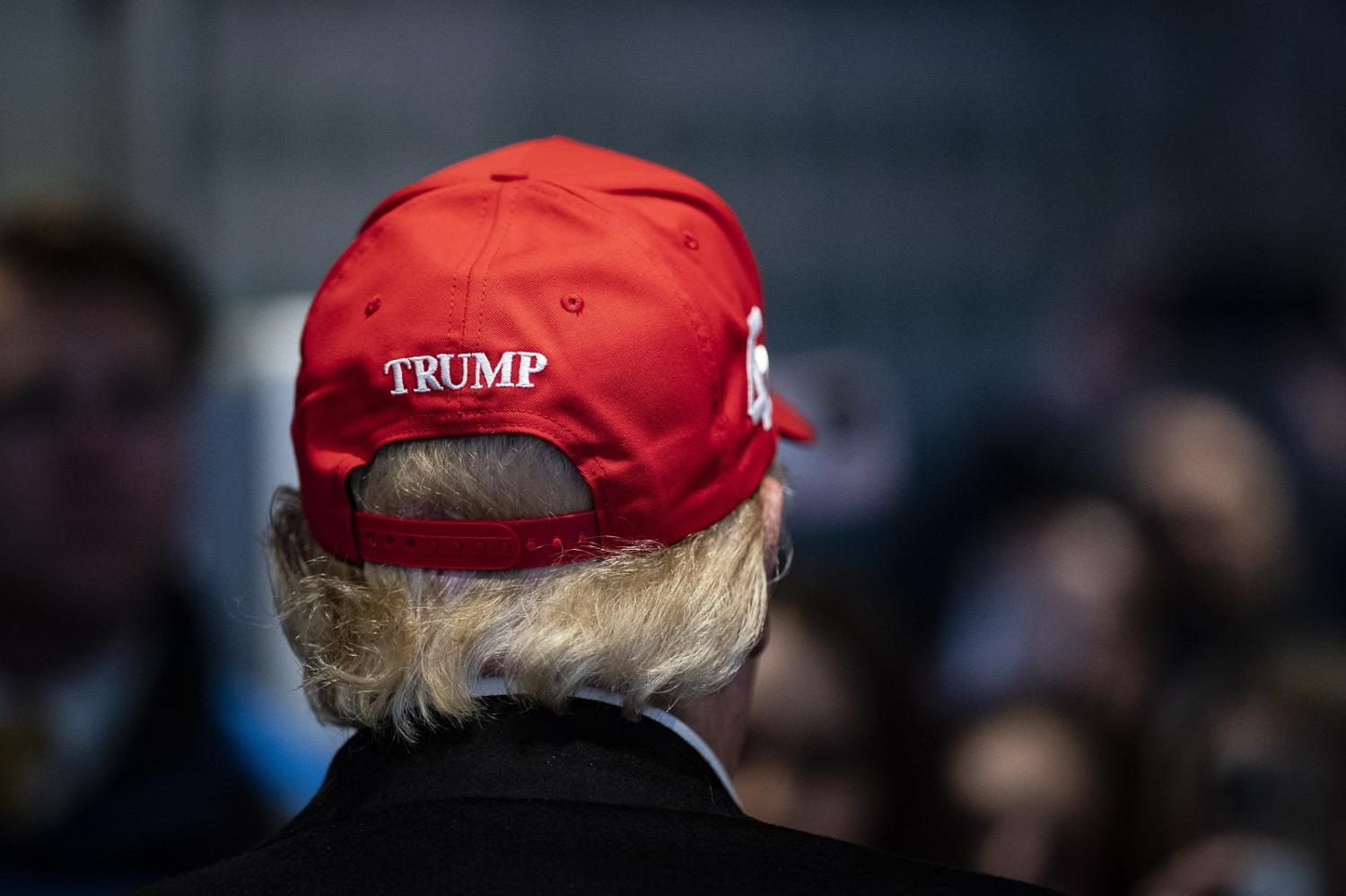 Former president Donald Trump hands out MAGA hats during an off-the-record stop at a McDonald's restaurant in East Palestine, Ohio, 22 February 2023 (Jabin Botsford/The Washington Post via Getty Images)